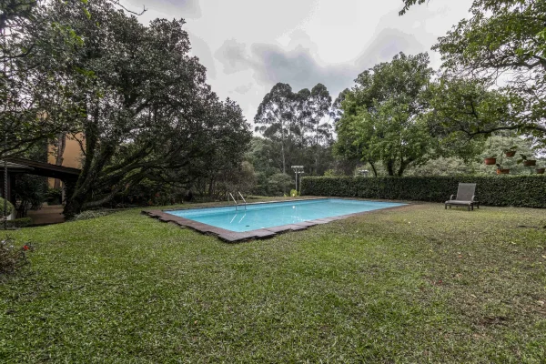 Casa rodeada por verde em rua fechada, tranquila e segura